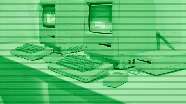 Vintage Apple computer on a dimly lit desk, evoking the heritage of the Mac
